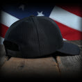 Load image into Gallery viewer, Blacked Out Debossed American Flag Trucker Hat
